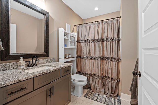 bathroom featuring vanity, curtained shower, toilet, and tile patterned flooring