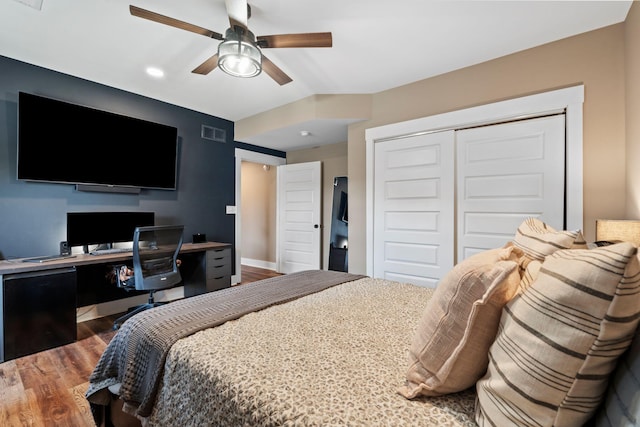 bedroom featuring a ceiling fan, wood finished floors, visible vents, and a closet