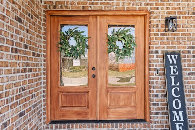 entrance to property featuring brick siding