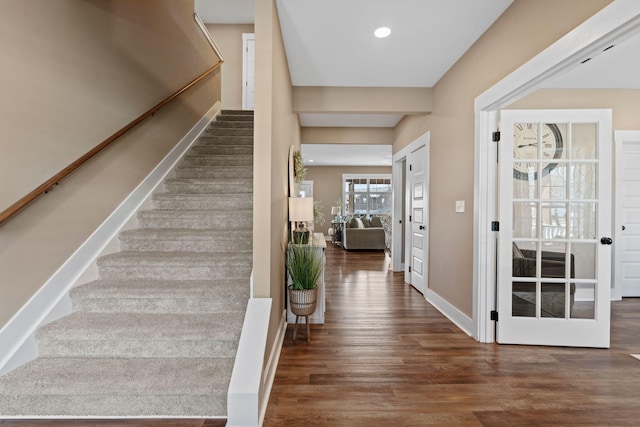 staircase featuring recessed lighting, wood finished floors, and baseboards