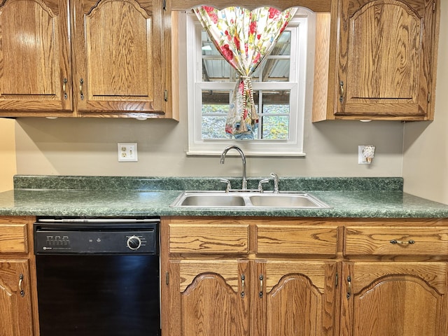 kitchen with dishwasher, dark countertops, brown cabinetry, and a sink