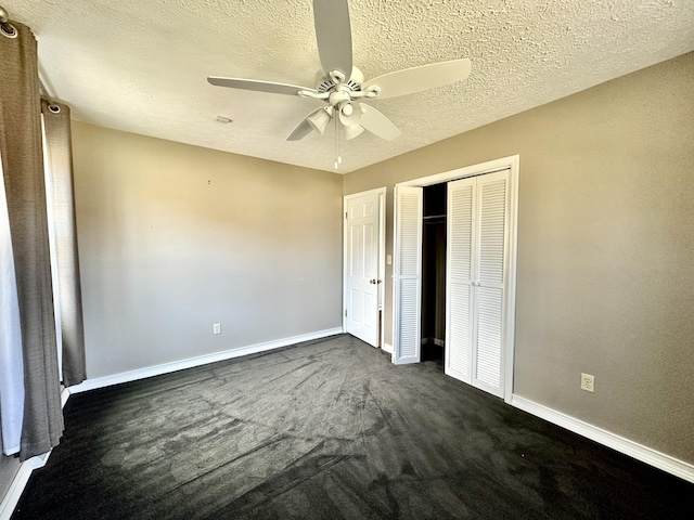 unfurnished bedroom featuring a closet, a textured ceiling, baseboards, and a ceiling fan