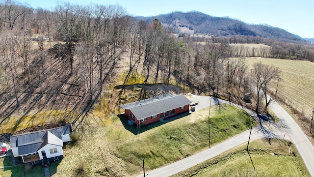 birds eye view of property featuring a mountain view and a wooded view