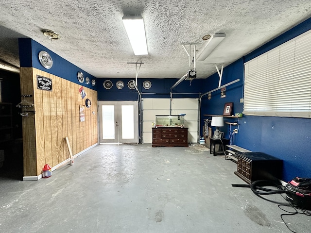 garage featuring french doors and a garage door opener