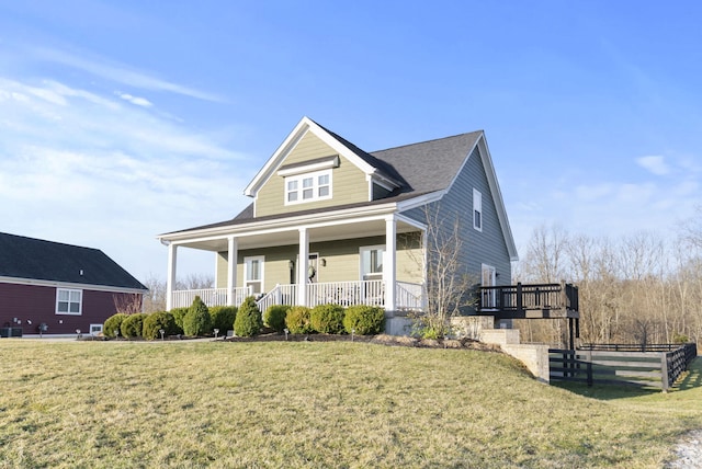 view of front of property with a porch, central AC, a front yard, and fence