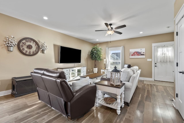 living area featuring recessed lighting, wood finished floors, and baseboards