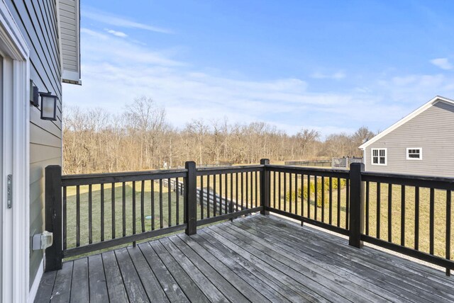 wooden deck with a lawn