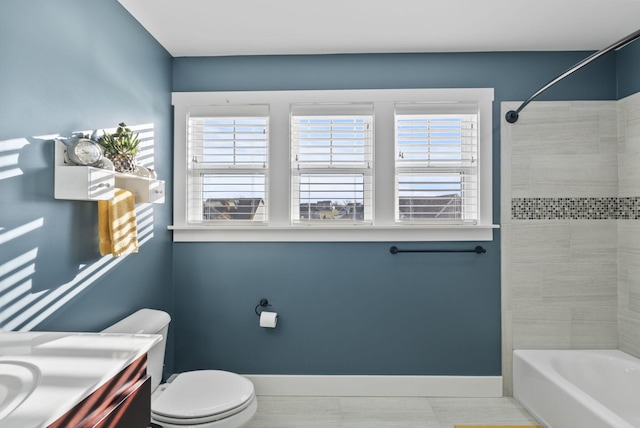 full bathroom featuring vanity, toilet, baseboards, and shower / bathtub combination