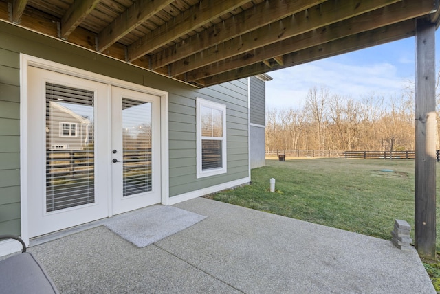 view of patio with french doors and fence