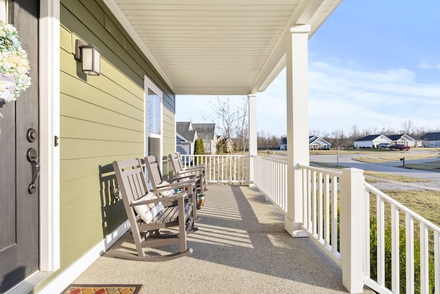 view of patio with a residential view and a porch