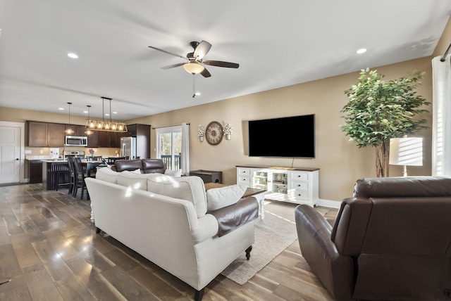 living room with recessed lighting, a ceiling fan, dark wood-style flooring, and baseboards