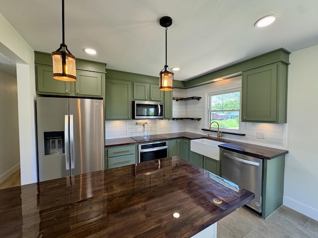 236 Walnut Ave, Somerset, KY 42503 - kitchen with green cabinets, stainless steel appliances, a sink, baseboards, and decorative backsplash