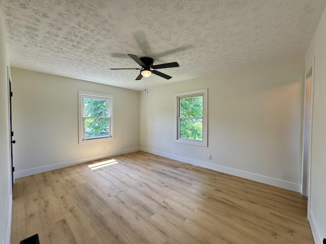 236 Walnut Ave, Somerset, KY 42503 - unfurnished room featuring plenty of natural light, light wood-style flooring, and a textured ceiling