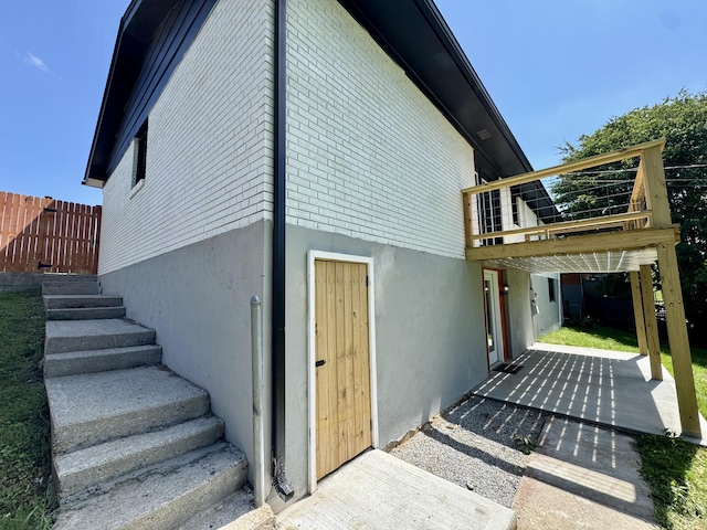 236 Walnut Ave, Somerset, KY 42503 - view of side of property featuring a patio area, stucco siding, fence, and a wooden deck