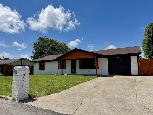 236 Walnut Ave, Somerset, KY 42503 - ranch-style house with a garage, concrete driveway, and brick siding