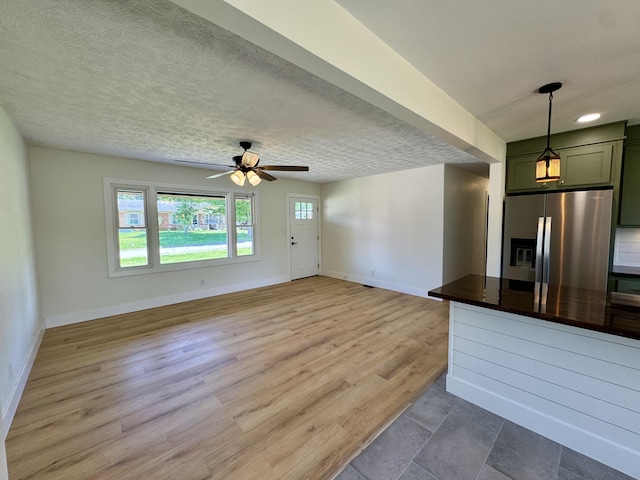 236 Walnut Ave, Somerset, KY 42503 - unfurnished living room with baseboards, a ceiling fan, wood finished floors, and a textured ceiling