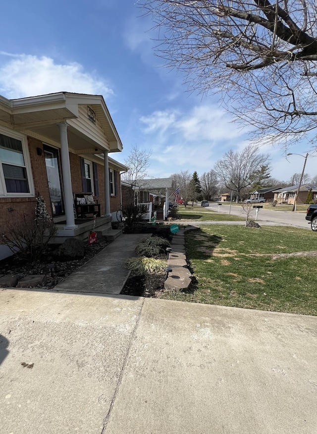 view of yard with concrete driveway