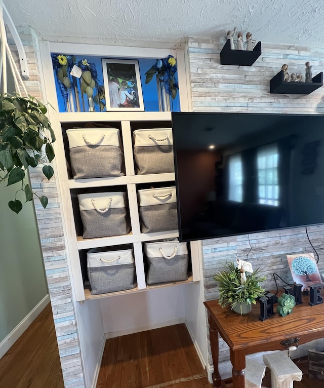 details featuring wood finished floors, baseboards, and a textured ceiling