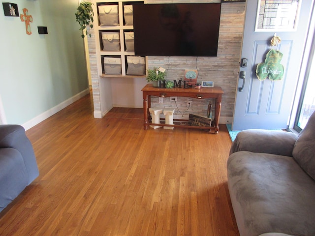 living area featuring wood finished floors and baseboards