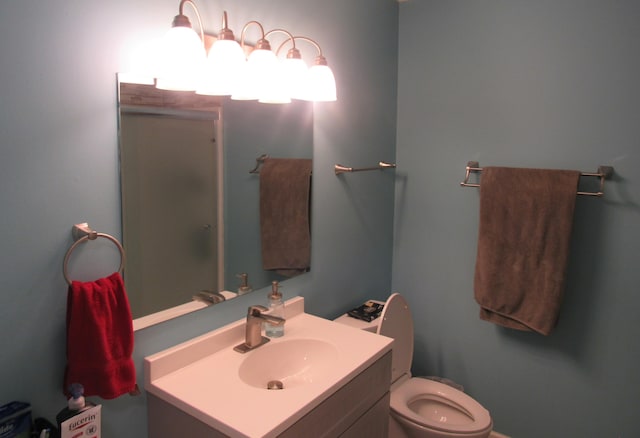 bathroom featuring toilet and vanity