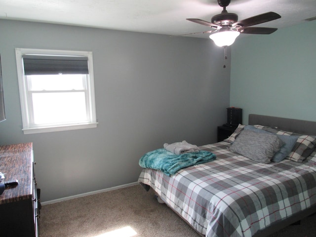 carpeted bedroom featuring ceiling fan and baseboards