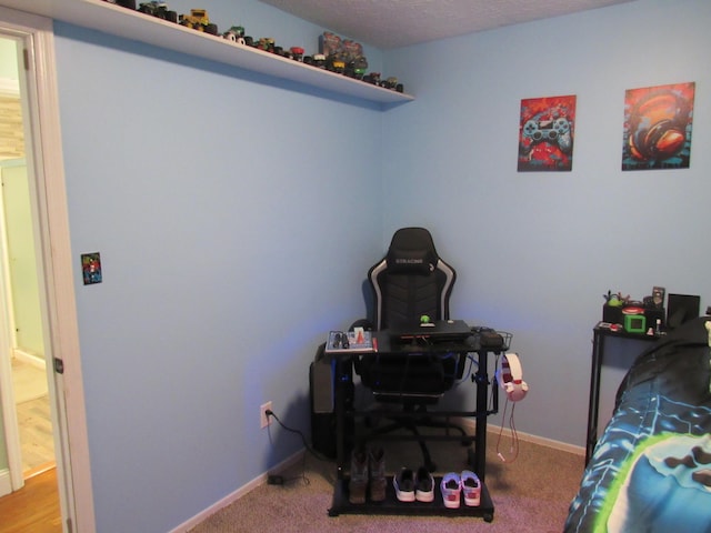 bedroom with baseboards, carpet floors, and a textured ceiling