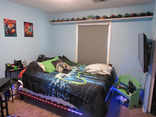 bedroom with carpet flooring, a textured ceiling, and visible vents