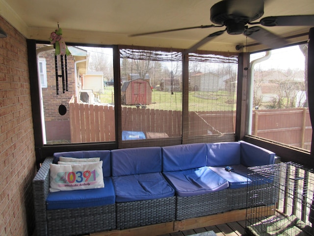 sunroom featuring ceiling fan