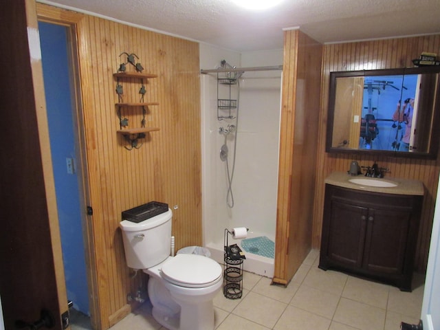 bathroom with a shower stall, toilet, wood walls, and tile patterned floors