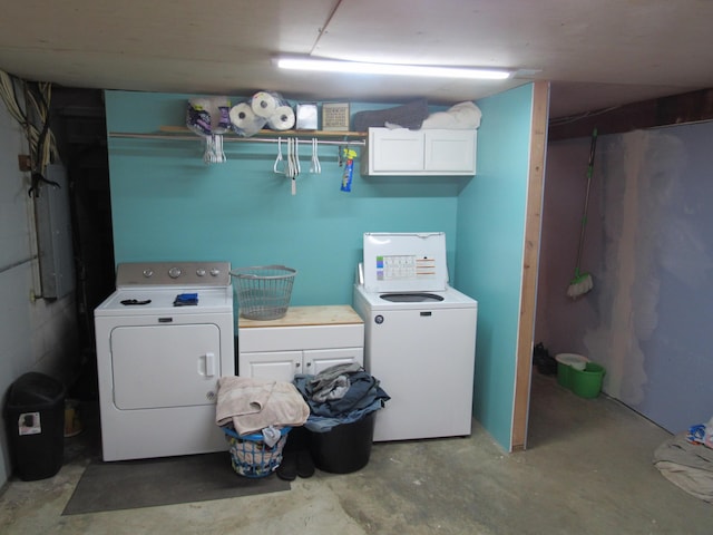 laundry area with electric panel, cabinet space, and separate washer and dryer