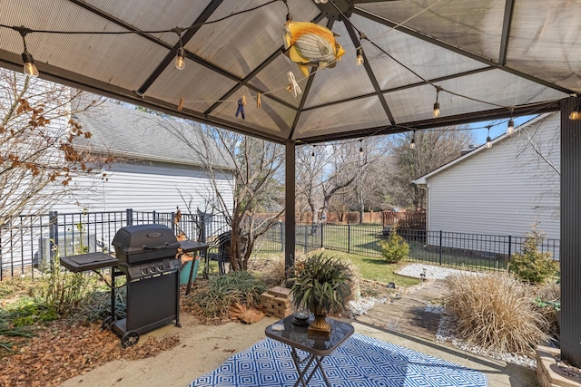 view of patio / terrace with a gazebo, area for grilling, and fence