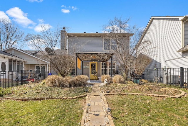 back of property featuring a lawn and fence