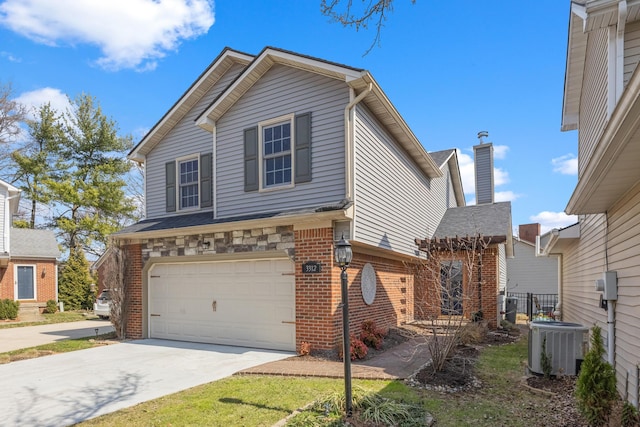 traditional-style house featuring brick siding, central AC unit, an attached garage, and driveway