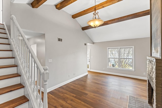 unfurnished living room featuring dark wood-type flooring, stairway, visible vents, and baseboards