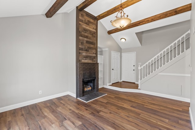 unfurnished living room with baseboards, wood finished floors, and stairs