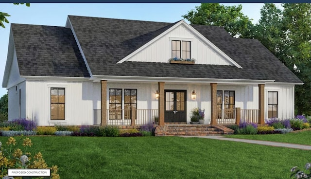 view of front of house with a porch, a front yard, and a shingled roof