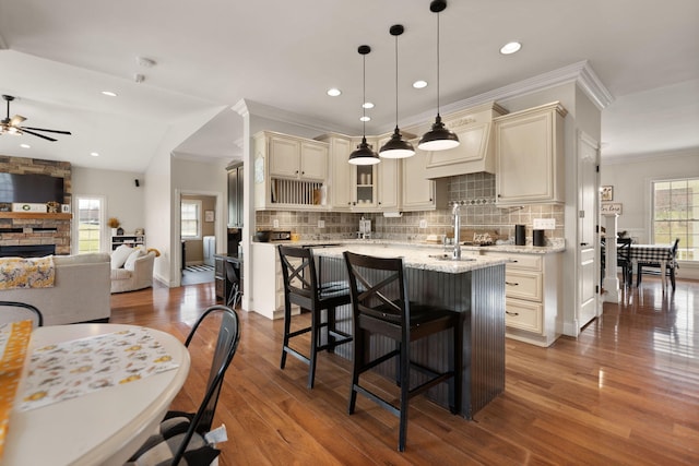 1841 Peter Cave Rd, Mckee, KY 40447 - kitchen with cream cabinetry, a ceiling fan, dark wood-type flooring, tasteful backsplash, and a stone fireplace