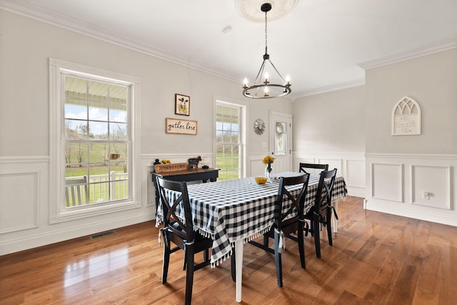 1841 Peter Cave Rd, Mckee, KY 40447 - dining space with a chandelier, wood finished floors, ornamental molding, a wainscoted wall, and a decorative wall