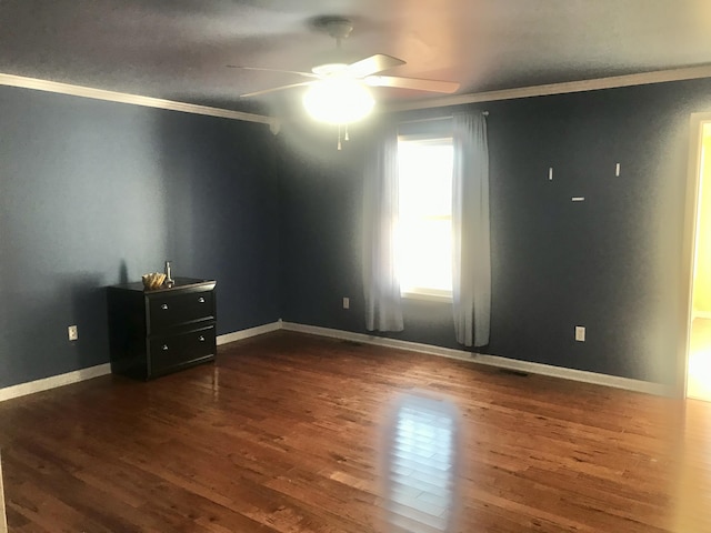 interior space featuring baseboards, crown molding, and dark wood-type flooring