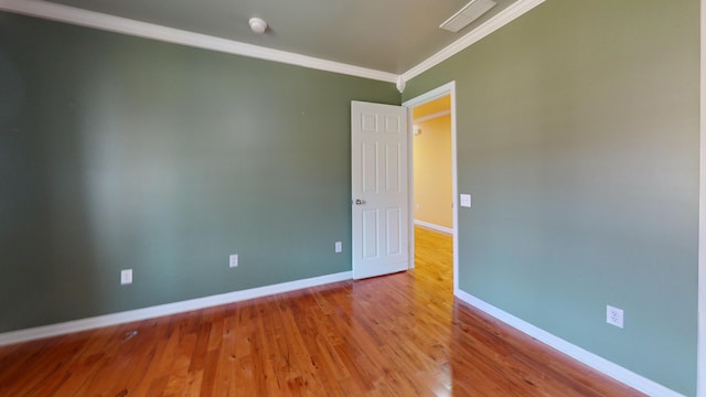 unfurnished room featuring visible vents, crown molding, baseboards, and wood finished floors