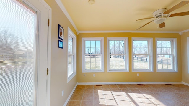 unfurnished sunroom featuring visible vents and a ceiling fan