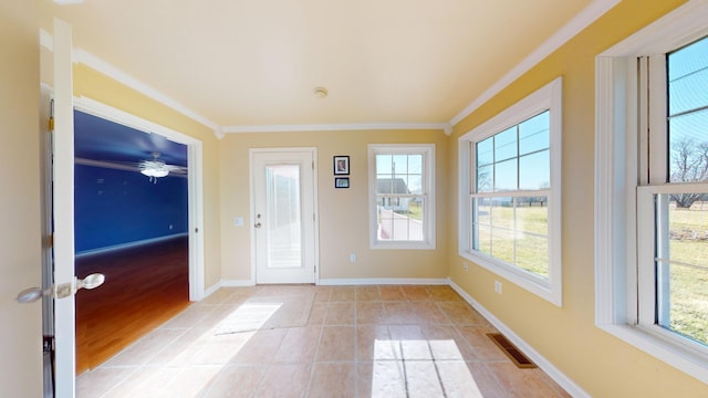 entrance foyer with light tile patterned floors, visible vents, crown molding, and baseboards