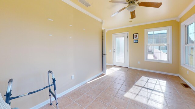 interior space featuring baseboards, visible vents, and ornamental molding