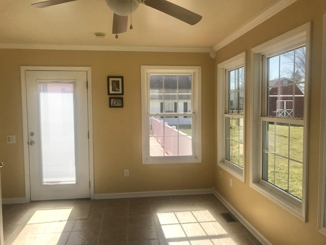 entryway with crown molding, baseboards, visible vents, and ceiling fan