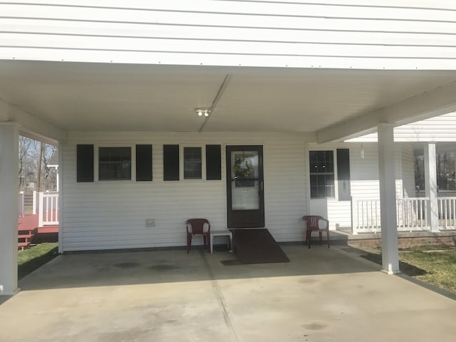 view of patio featuring a carport and a porch