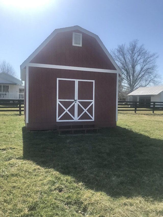 view of outbuilding featuring an outdoor structure and fence