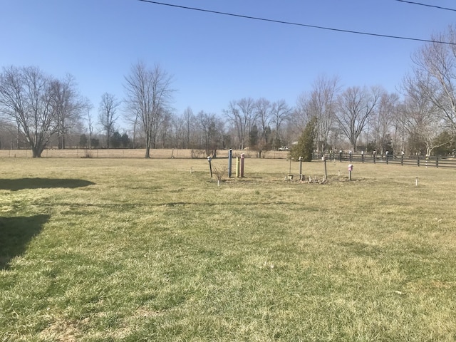 view of yard with a rural view and fence