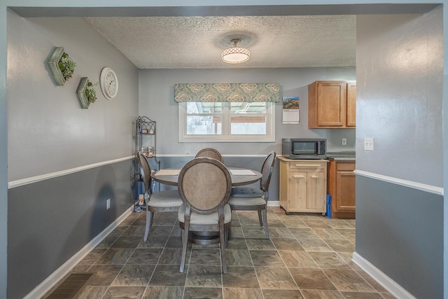 1317 Drydock Rd, Lawrenceburg, KY 40342 - dining room with visible vents, baseboards, and a textured ceiling