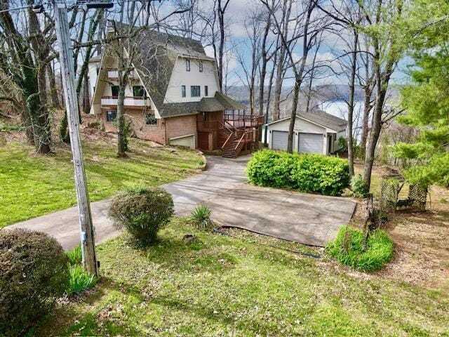 exterior space with an outbuilding, a lawn, and a detached garage