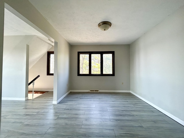 3101 Simpson Dr, Somerset, KY 42503 - spare room with visible vents, plenty of natural light, a textured ceiling, and baseboards
